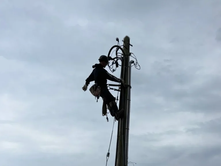 Dunne Power lineman working at the top of a hydro pole