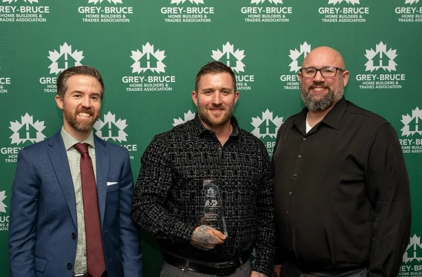 Tom Dunne with the trophy at the Grey-Bruce Home Builders and Trades Association Awards of Distinction 2025