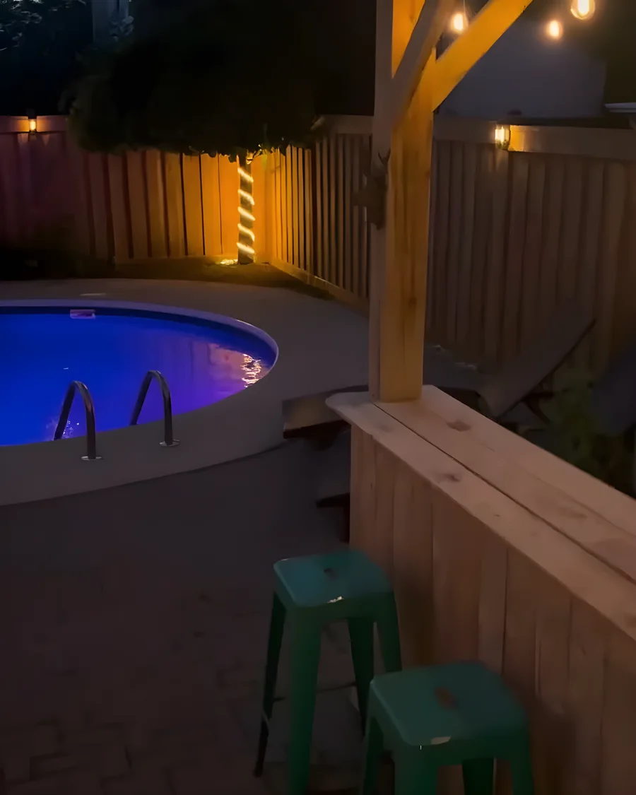 Backyard tiki bar and gazebo lit by newly installed outdoor lighting in Owen Sound