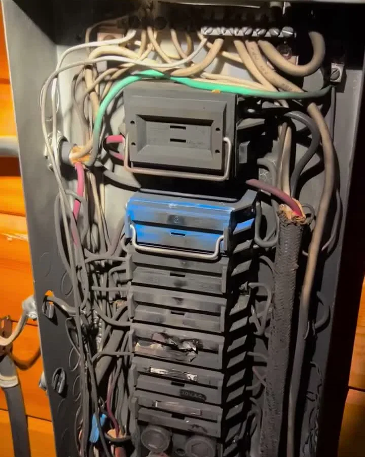 The burnt-out fuse panel that took this home's power, before Dunne Power replaced it