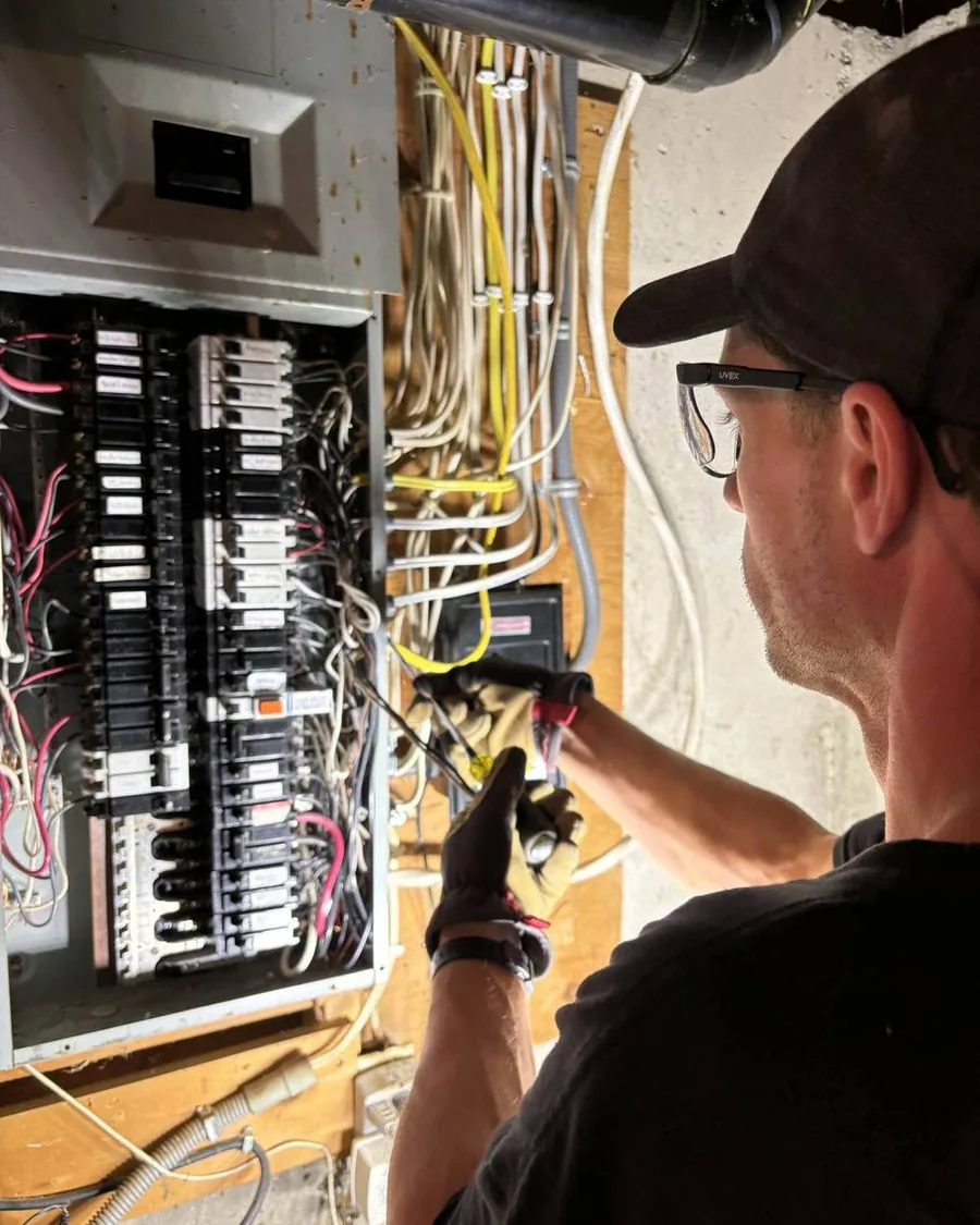Dunne Power electrician wiring a new electrical panel on site