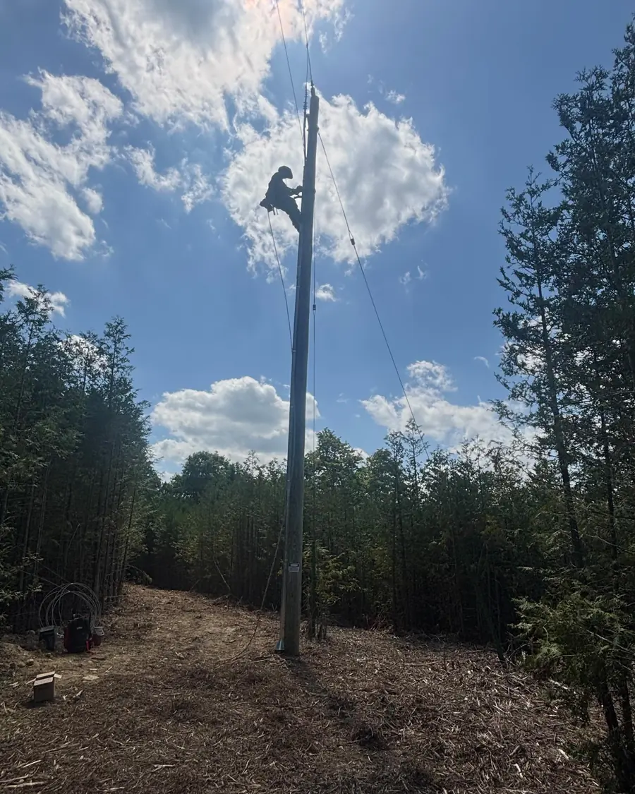 Dunne Power lineman working at the top of a hydro pole